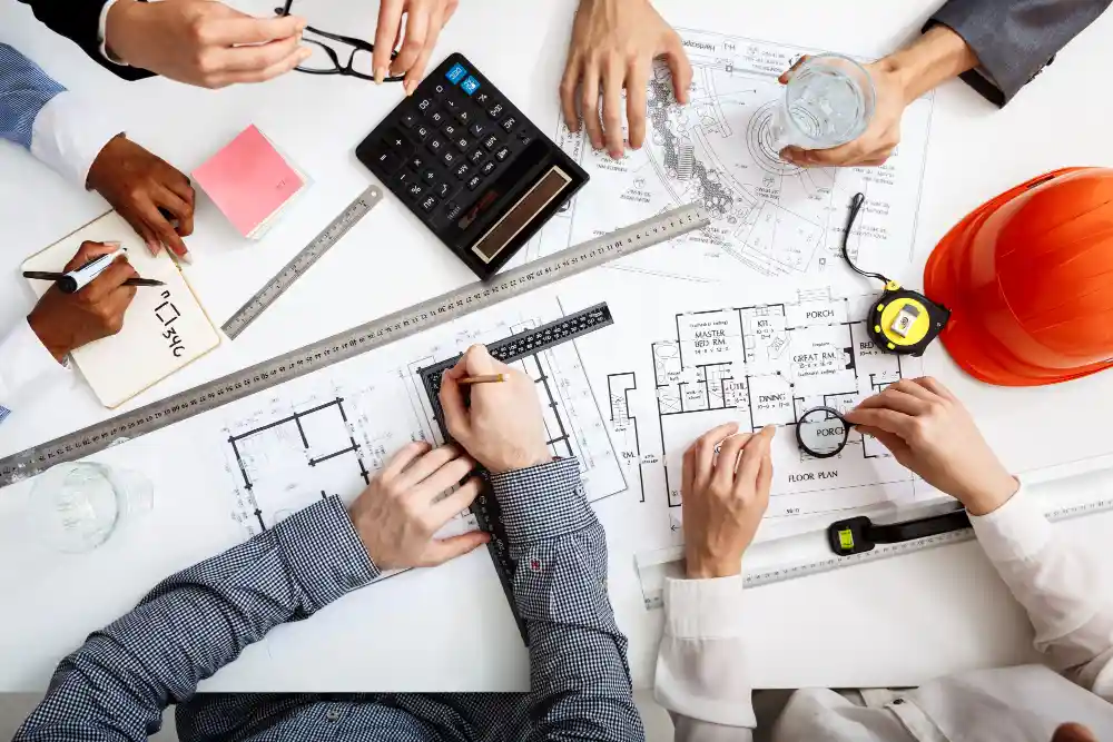 Commercial Construction Company in Illawarra planning a commercial building project with blueprints and schedules